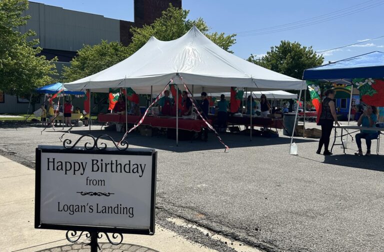 A sign that says Happy Birthday in front of a large tent at the Celebrate Logansport event in downtown Logansport on June 6, 2024.